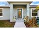 Front porch with two chairs and welcome sign at 12385 Prudential Ave, Port Charlotte, FL 33981