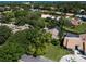 Aerial view of the house and community showcasing mature trees and landscaping at 128 Sea Anchor Dr, Osprey, FL 34229