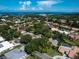 Beautiful aerial view of a residential area with lush greenery and a glimpse of the ocean in the background at 128 Sea Anchor Dr, Osprey, FL 34229