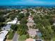 Aerial view of the house and community showcasing the water and other homes nearby at 128 Sea Anchor Dr, Osprey, FL 34229