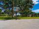 Outdoor basketball court surrounded by mature trees and green space at 128 Sea Anchor Dr, Osprey, FL 34229