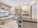 Luxurious bathroom with a soaking tub, marble counters, and ample vanity space at 128 Sea Anchor Dr, Osprey, FL 34229