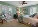 Inviting bedroom with French doors leading to the outdoors and a ceiling fan at 128 Sea Anchor Dr, Osprey, FL 34229