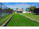 Outdoor Bocce ball court and covered seating area with lush landscaping at 128 Sea Anchor Dr, Osprey, FL 34229