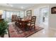 Elegant dining room featuring a wooden table, bay window, and decorative rug at 128 Sea Anchor Dr, Osprey, FL 34229