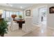 Charming dining room with a hardwood table, white chairs, and a bay window providing natural light at 128 Sea Anchor Dr, Osprey, FL 34229