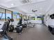 Community gym with modern exercise equipment, large windows, televisions, and ample space for workouts at 128 Sea Anchor Dr, Osprey, FL 34229