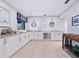 Bright kitchen featuring marble countertops, white cabinetry, stainless steel appliances, and nautical decor at 128 Sea Anchor Dr, Osprey, FL 34229