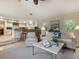 Bright living room showcasing the open layout connecting to the kitchen and dining areas at 128 Sea Anchor Dr, Osprey, FL 34229