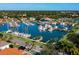 Aerial view of a marina showcasing numerous boats docked in the water near lush green trees at 128 Sea Anchor Dr, Osprey, FL 34229