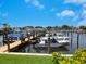 Marina with boats docked and green lawn at 128 Sea Anchor Dr, Osprey, FL 34229