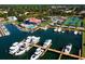 Overhead shot of a marina with a variety of boats, a clubhouse, and a swimming pool at 128 Sea Anchor Dr, Osprey, FL 34229