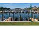 Docks with boats in the marina and green lawn at 128 Sea Anchor Dr, Osprey, FL 34229