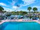 Poolside lounge with lounge chairs overlooking the water, boats, and marina at 128 Sea Anchor Dr, Osprey, FL 34229