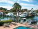 Poolside lounge with chairs overlooking marina, complete with boats and lush landscaping at 128 Sea Anchor Dr, Osprey, FL 34229