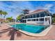 Large community pool with lounge chairs adjacent to the clubhouse at 128 Sea Anchor Dr, Osprey, FL 34229