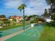 Community shuffleboard court and seating with views of lovely homes at 128 Sea Anchor Dr, Osprey, FL 34229