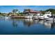 Picturesque waterfront scene with boats docked along the pier near a multi-story building at 128 Sea Anchor Dr, Osprey, FL 34229