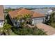 This aerial shot shows the tile roof, paver driveway, and lush landscaping of this beautiful home at 13194 Borrego St, Venice, FL 34293