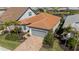 Overhead shot shows this home's attractive curb appeal with a tile roof and a gray two-car garage at 13194 Borrego St, Venice, FL 34293