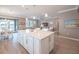 Kitchen and living area with an island, pendant lights, and stainless steel appliances at 13194 Borrego St, Venice, FL 34293