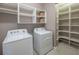 Efficient laundry room equipped with washer, dryer and custom shelving at 13194 Borrego St, Venice, FL 34293