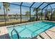 Screened in pool overlooking scenic water view with ample space for outdoor seating at 13194 Borrego St, Venice, FL 34293