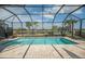 Relaxing screened pool area with seating, palm trees and lovely lake view at 13194 Borrego St, Venice, FL 34293