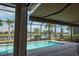 The screened-in pool area provides a tranquil retreat with views of the surrounding lake and palm trees at 13194 Borrego St, Venice, FL 34293