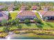 Home with pool and lake view from above at 13376 Caravaggio Ct, Venice, FL 34293