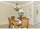 Elegant dining room with a wooden table, six chairs and access to the foyer at 13376 Caravaggio Ct, Venice, FL 34293