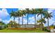 Grand entrance to Gran Paradiso community with lush landscaping and palm trees at 13376 Caravaggio Ct, Venice, FL 34293