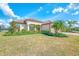 Single-story home with tile roof, two-car garage, and manicured lawn at 13376 Caravaggio Ct, Venice, FL 34293