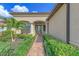 Inviting walkway to front door, landscaped with palm trees and shrubs at 13376 Caravaggio Ct, Venice, FL 34293