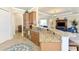 Open kitchen with granite island, stainless steel appliances, and breakfast bar at 13376 Caravaggio Ct, Venice, FL 34293