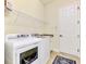 Laundry room with washer, dryer, and overhead shelving at 13376 Caravaggio Ct, Venice, FL 34293