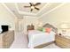 Luxurious Primary bedroom with king bed, dresser, and access to the bathroom at 13376 Caravaggio Ct, Venice, FL 34293