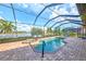 Enclosed pool and spa with lounge chairs and lake view at 13376 Caravaggio Ct, Venice, FL 34293