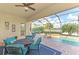 Relaxing pool area with patio furniture and lake view at 13376 Caravaggio Ct, Venice, FL 34293