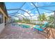 Screened pool area with lounge chairs and backyard view at 13376 Caravaggio Ct, Venice, FL 34293