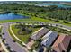 Aerial view of community with houses and a lake at 13463 Nobilio St, Venice, FL 34293