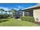 Landscaped backyard with a screened patio and lush greenery at 13463 Nobilio St, Venice, FL 34293