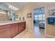 Double vanity bathroom with granite countertop and tiled shower at 13463 Nobilio St, Venice, FL 34293