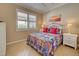 Bedroom with colorful bedding and white nightstands at 13463 Nobilio St, Venice, FL 34293