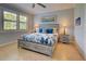 Bright bedroom featuring a king-size bed and plenty of natural light at 13463 Nobilio St, Venice, FL 34293