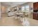 Bright dining area with a table, chairs, and view of the living room at 13463 Nobilio St, Venice, FL 34293