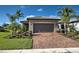 Front view of house with brown garage door and landscaped yard at 13463 Nobilio St, Venice, FL 34293