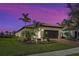 Single-story house with tile roof and landscaped yard at dusk at 13463 Nobilio St, Venice, FL 34293