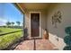 Screened porch entry with dark brown door and tile flooring at 13463 Nobilio St, Venice, FL 34293