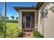 Front entry with screened porch, brick flooring, and decorative wall art at 13463 Nobilio St, Venice, FL 34293